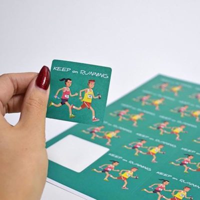 personalised sticker designs - square stickers - image of woman's hand peeling off a sticker from a sheet of labels