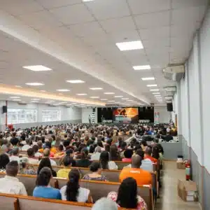 Industry Print 1 corporate event with many people in the audience and roller banner print on the stage