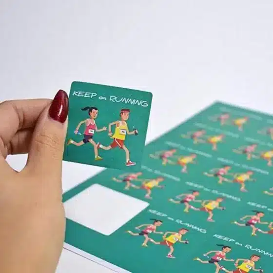 personalised square label sticker designs - square stickers - image of woman's hand peeling off a sticker from a sheet of labels